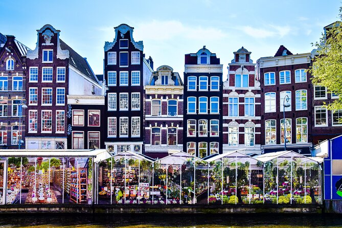 Amsterdam Day Trip from Brussels With Cheese, Clogs and Windmills - Arriving in Amsterdam: Dam Square and the city-orientation walk