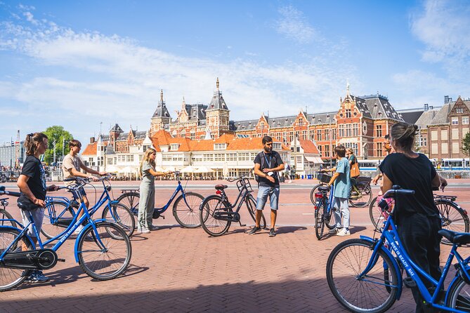 Amsterdam Small-Group Bike Tour With Canal Cruise, Drinks, Cheese - The start at Nieuwezijds Voorburgwal and the rhythm of the ride
