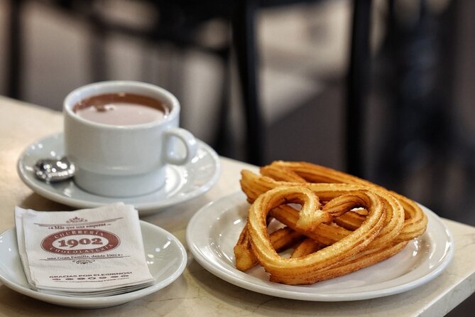 Madrid Bike Tour with Churros and Wine, Ham, and Cheese Upgrade - Plaza de Cibeles, Puerta de Alcalá, and the Neptune Fountain Near Prado